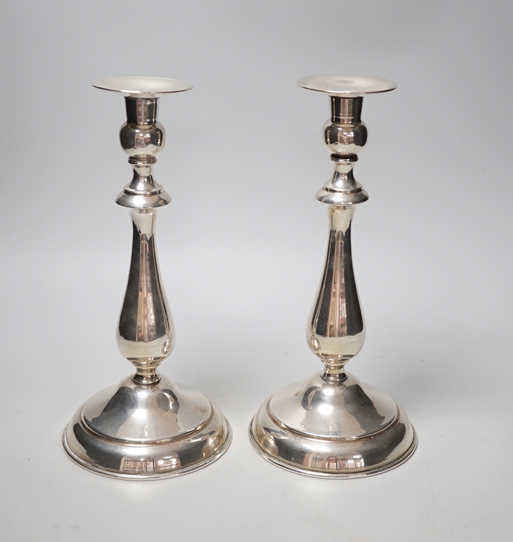 A pair of continental white metal candlesticks, stamped SK 900, height 25.3cm, gross 18.3oz.